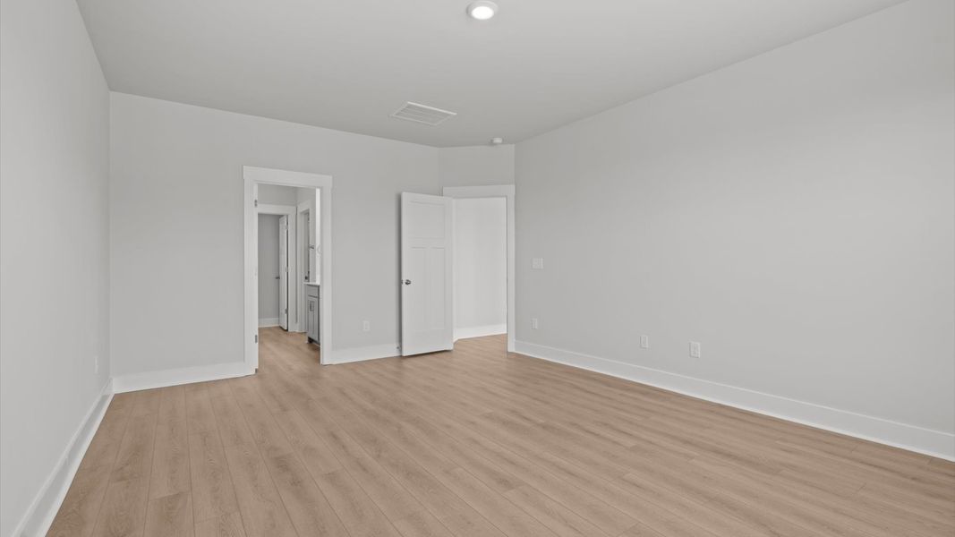 Accomplished primary retreat with eye-catching hardwood flooring in a desirable Anderson community