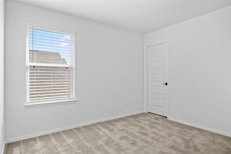 Carpeted spare room with baseboards