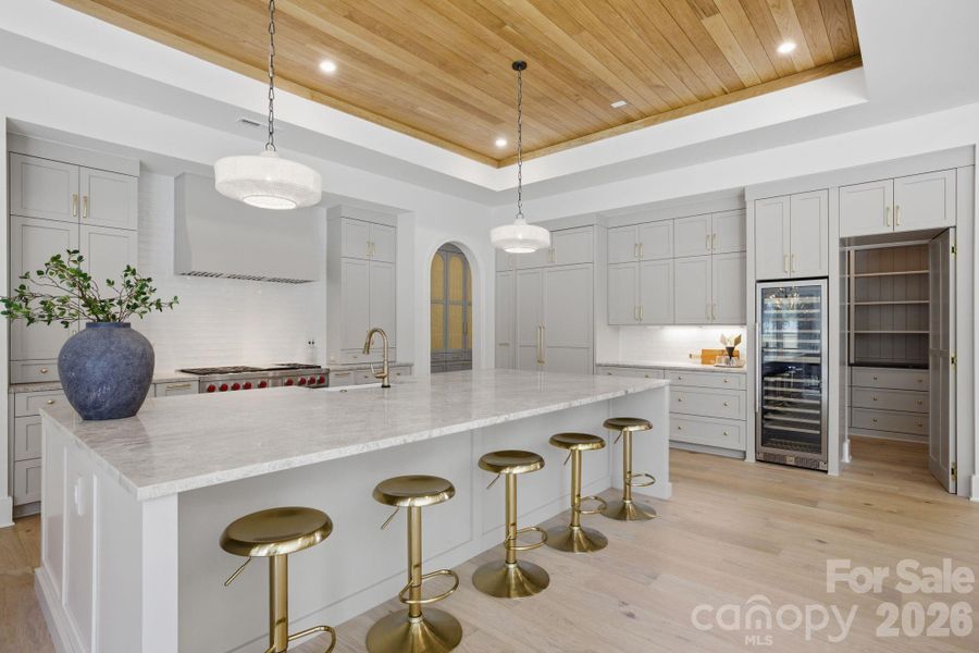 Kitchen Layout Features a Hidden Cabinet Door Into a Full Pantry mages represent a previously completed home by the builder showcasing a similar design and layout. Photos are intended to reflect overall design intent and craftsmanship; actual selections, materials, finishes, and features for this home may differ
