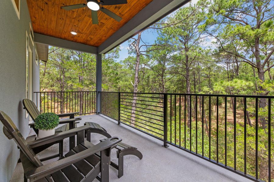 Enjoy tranquil woodland views from this covered outdoor living space with a stylish wooden ceiling and integrated lighting.