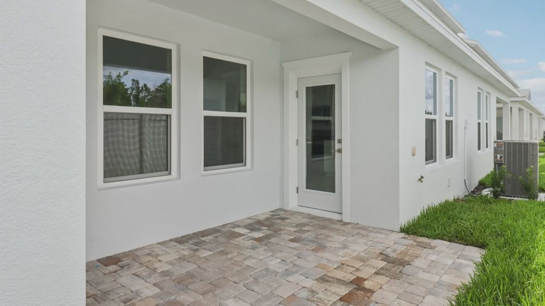 Exterior details and patio area of a home in Cyrene at Harmony, St. Cloud (Image 4).