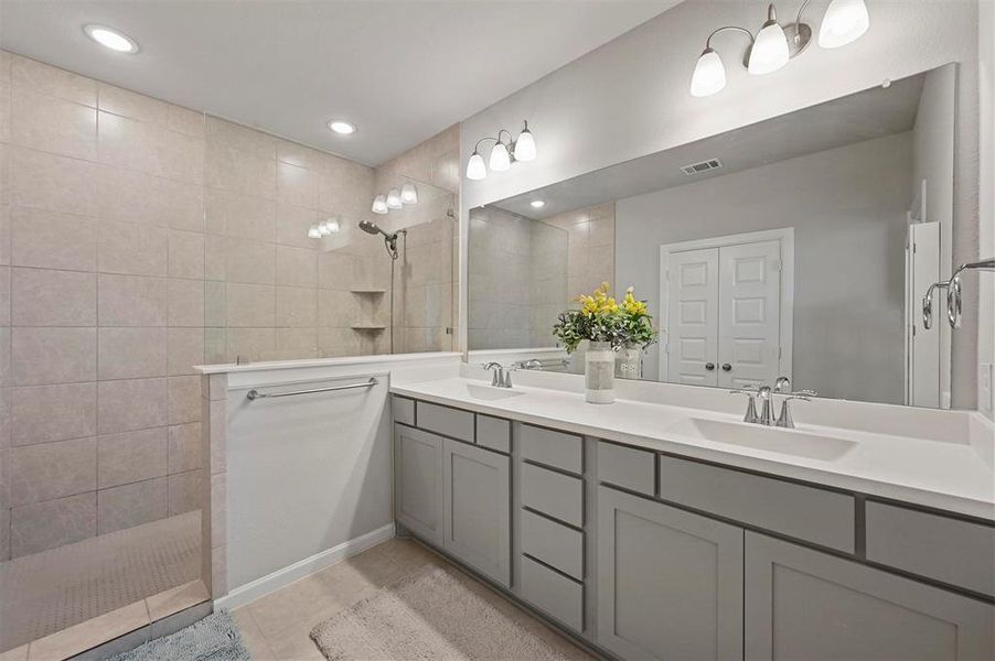 Full bathroom featuring double vanity, a walk in shower, tile patterned floors, and recessed lighting Full bathroom featuring double vanity, a walk in shower, tile patterned floors, and recessed lighting