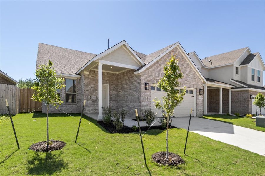View of front of house featuring driveway, an attached garage, a front yard, brick siding, and fence View of front of house featuring driveway, an attached garage, a front yard, brick siding, and fence