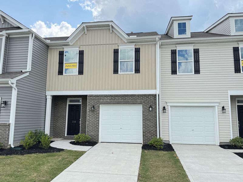 Front exterior of a new home in Bellevue Townhomes, Greenville, SC, highlighting curb appeal (Image 1).