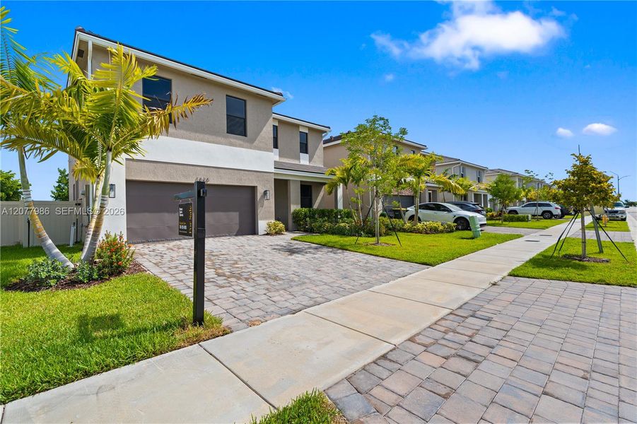 Front exterior of a new home in Parker Pointe, Homestead, FL, highlighting curb appeal (Image 22). Front exterior of a new home in Parker Pointe, Homestead, FL, highlighting curb appeal (Image 22).