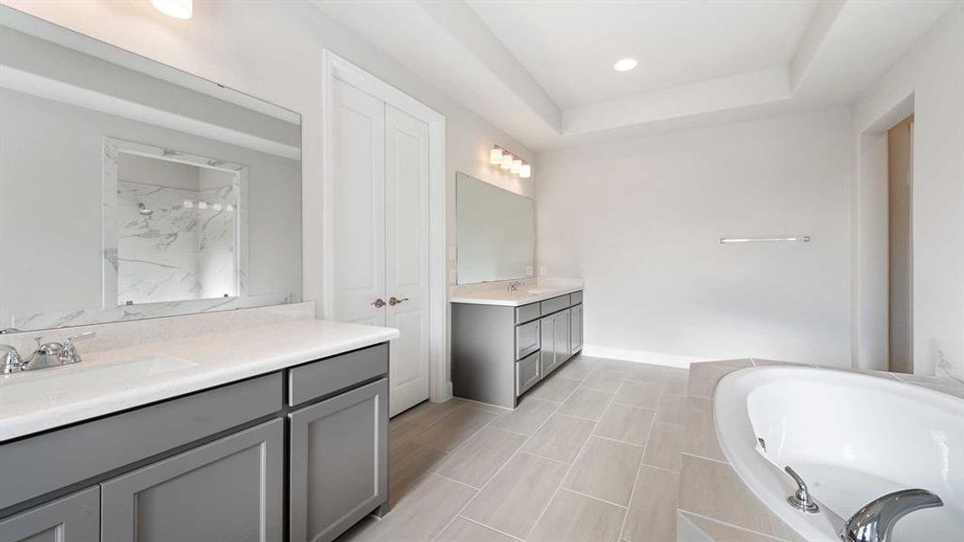 Bathroom featuring separate shower and tub and vanity