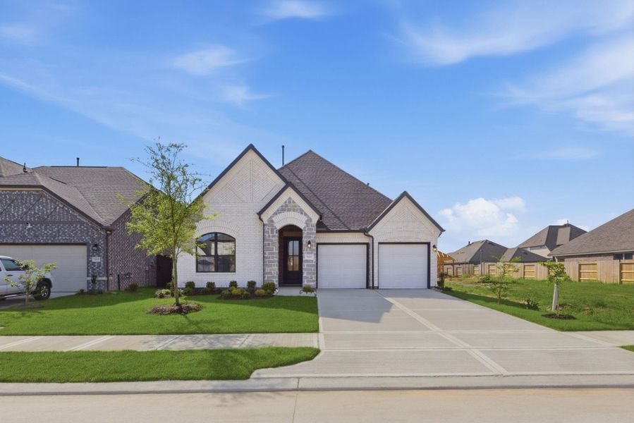 Front exterior of a new home in Brookewater, Rosenberg, TX, highlighting curb appeal (Image 2). Front exterior of a new home in Brookewater, Rosenberg, TX, highlighting curb appeal (Image 2).