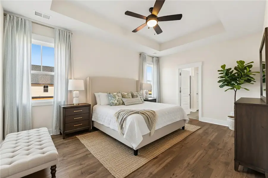 This primary bedroom offers ample space, warm wood