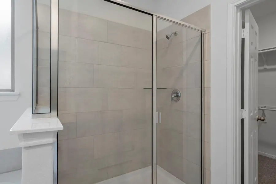 This additional view of your primary bathroom features tile flooring, fresh paint, walk-in shower, a separate garden tub, and a large walk-in closet. This additional view of your primary bathroom features tile flooring, fresh paint, walk-in shower, a separate garden tub, and a large walk-in closet.