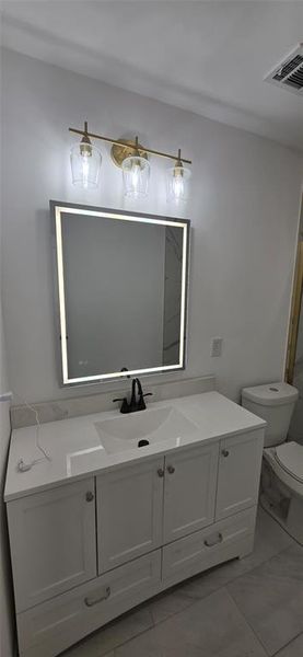 Bathroom with vanity and toilet