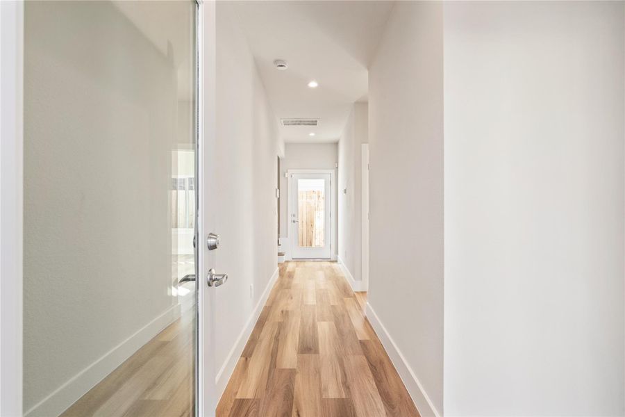 The entry sets the tone, a quiet arrival that leads you through the home before opening into the main living level above.