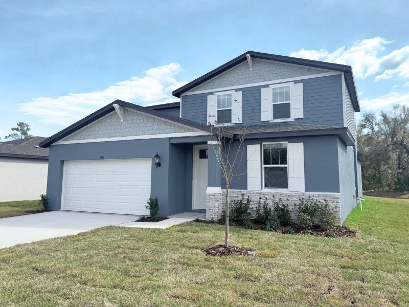 Front exterior of a new home in Leyland Preserve - Classic Series, Brooksville, FL, highlighting curb appeal (Image 2). Front exterior of a new home in Leyland Preserve - Classic Series, Brooksville, FL, highlighting curb appeal (Image 2).