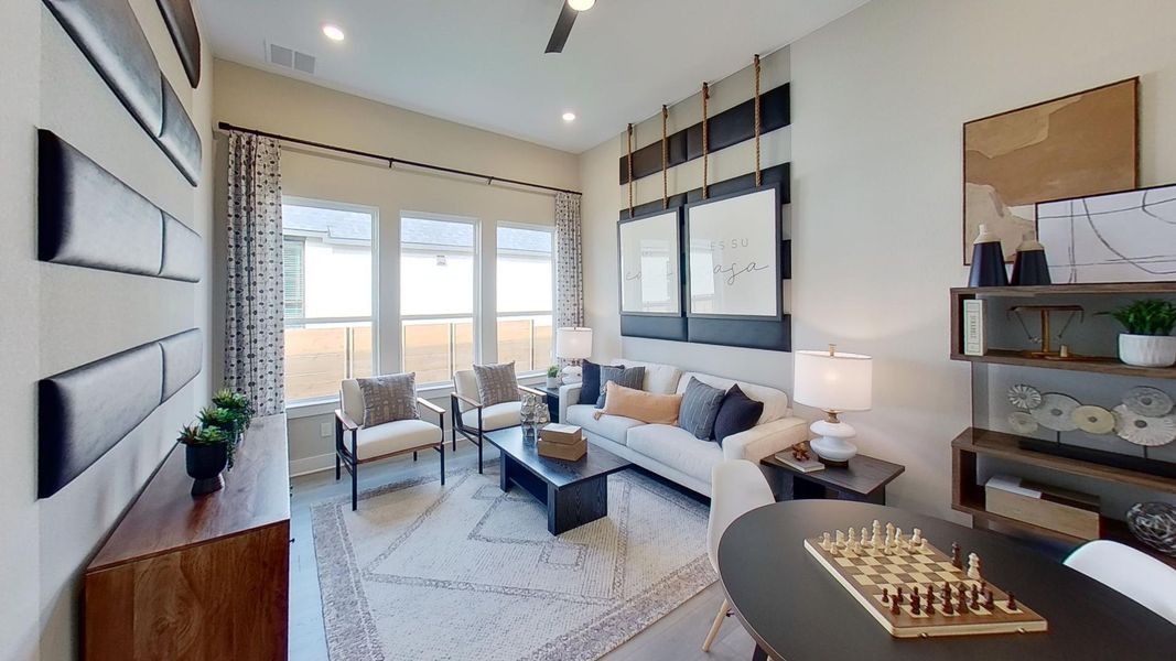 Living room with light wood-style flooring and recessed lighting