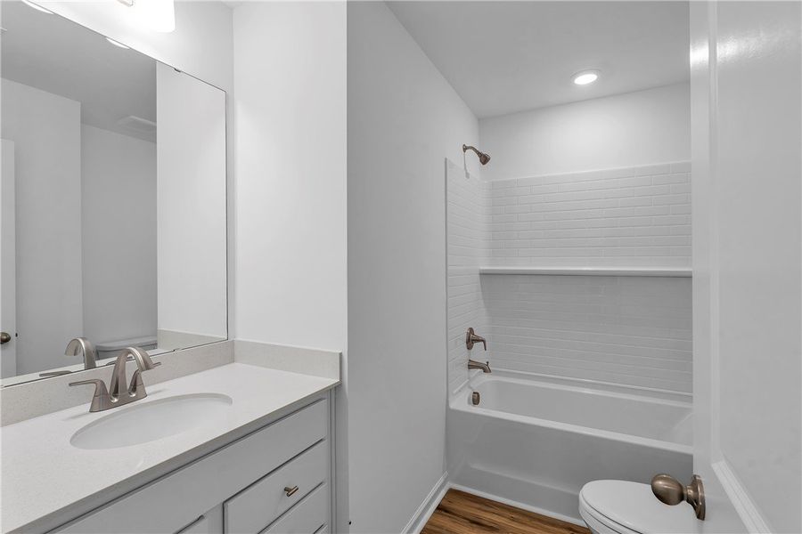 This modern bathroom features a single vanity, a s This modern bathroom features a single vanity, a s