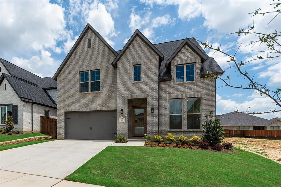 Front exterior of a new home in Tavolo Park, Fort Worth, TX, highlighting curb appeal (Image 25). Front exterior of a new home in Tavolo Park, Fort Worth, TX, highlighting curb appeal (Image 25).