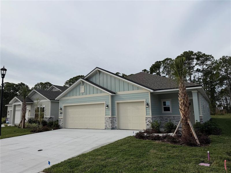 Front exterior of a new home in The Magnolia Series at Reserve East, Flagler Beach, FL, highlighting curb appeal (Image 2). Front exterior of a new home in The Magnolia Series at Reserve East, Flagler Beach, FL, highlighting curb appeal (Image 2).