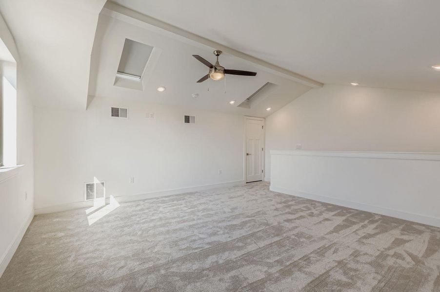 Spare room with light carpet, recessed lighting, attic access, and a ceiling fan