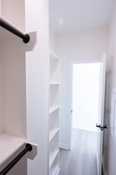 Primary bedroom walk in closet