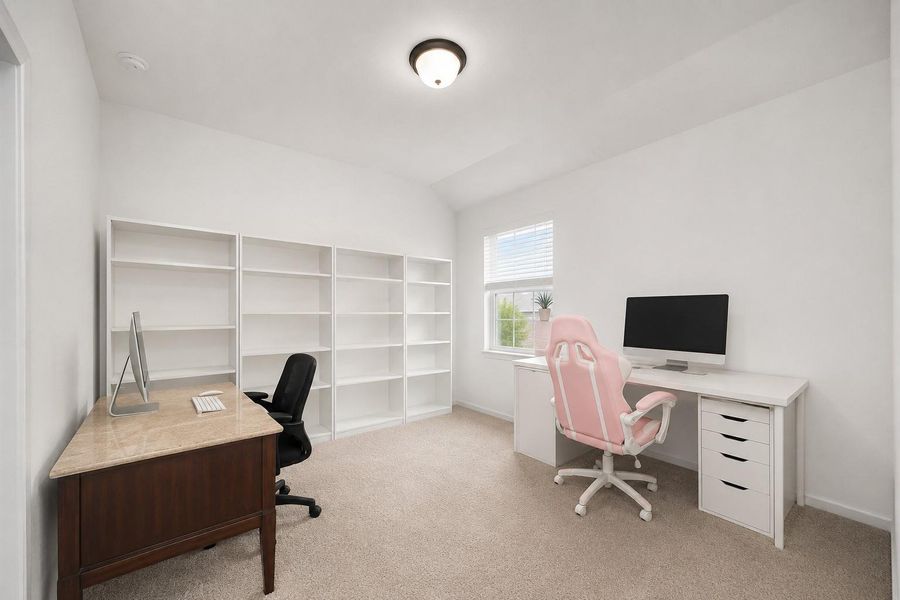 Bright and spacious home office with neutral walls and carpet. Features dual desks, ample shelving, and a large window for natural light. Ideal for productivity and organization. Bright and spacious home office with neutral walls and carpet. Features dual desks, ample shelving, and a large window for natural light. Ideal for productivity and organization.