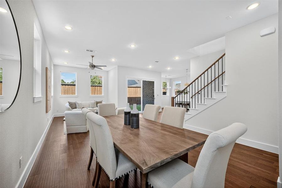 Dining room with recessed lighting, stairway, dark wood-style flooring, and ceiling fan