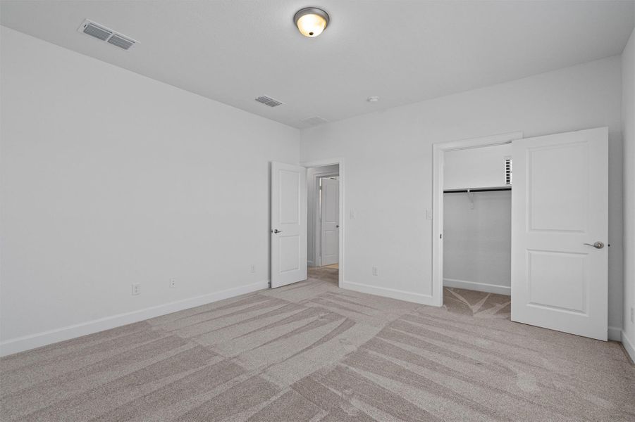 Carpeted room featuring white walls, white trim, and a flush mount ceiling light