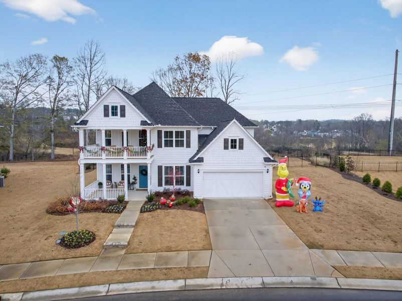Front exterior of a new home in Reunion, Flowery Branch, GA, highlighting curb appeal (Image 2). Front exterior of a new home in Reunion, Flowery Branch, GA, highlighting curb appeal (Image 2).