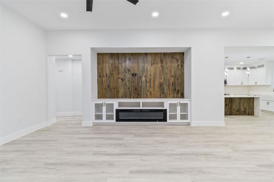 Unfurnished living room with light wood finished floors, recessed lighting, and ceiling fan