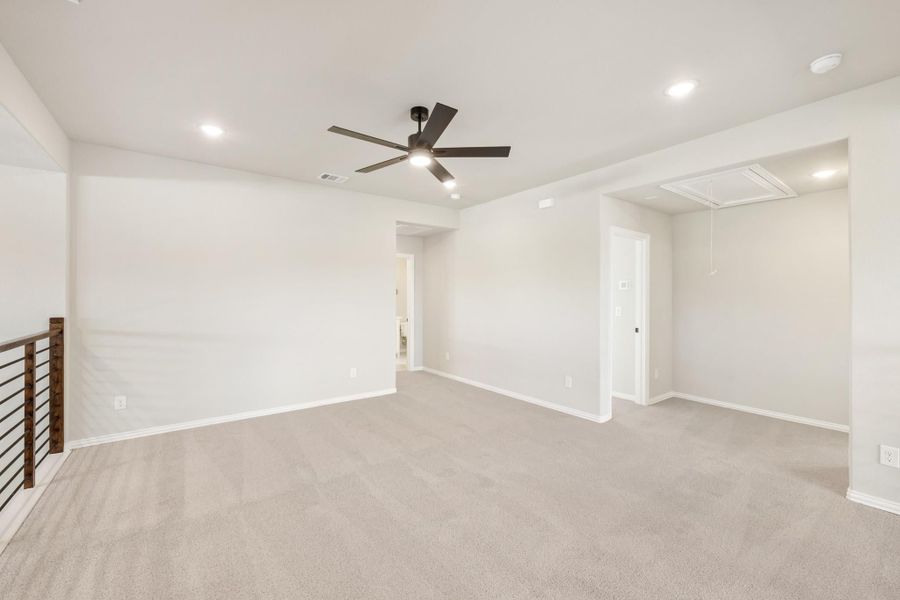 Open upstairs loft or bonus room with carpet, ceiling fan, recessed lighting, and attic access panel. Open upstairs loft or bonus room with carpet, ceiling fan, recessed lighting, and attic access panel.