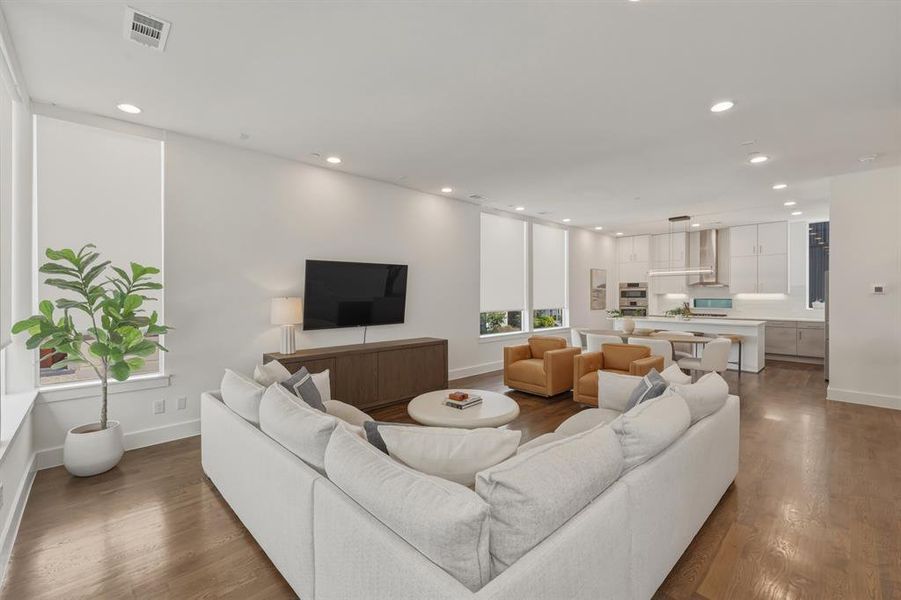 Living room with wood finished floors and recessed lighting
