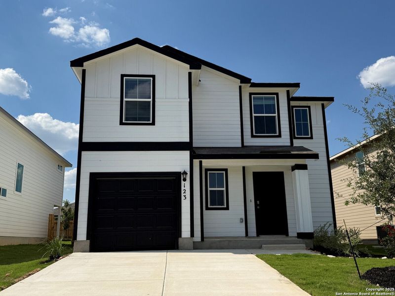 Front exterior of a new home in Redbird Ranch, San Antonio, TX, highlighting curb appeal (Image 22). Front exterior of a new home in Redbird Ranch, San Antonio, TX, highlighting curb appeal (Image 22).