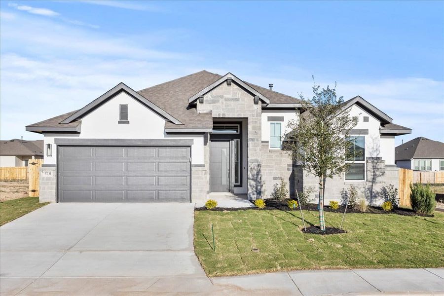 Front exterior of a new home in Village at Three Oaks, Seguin, TX, highlighting curb appeal (Image 2). Front exterior of a new home in Village at Three Oaks, Seguin, TX, highlighting curb appeal (Image 2).