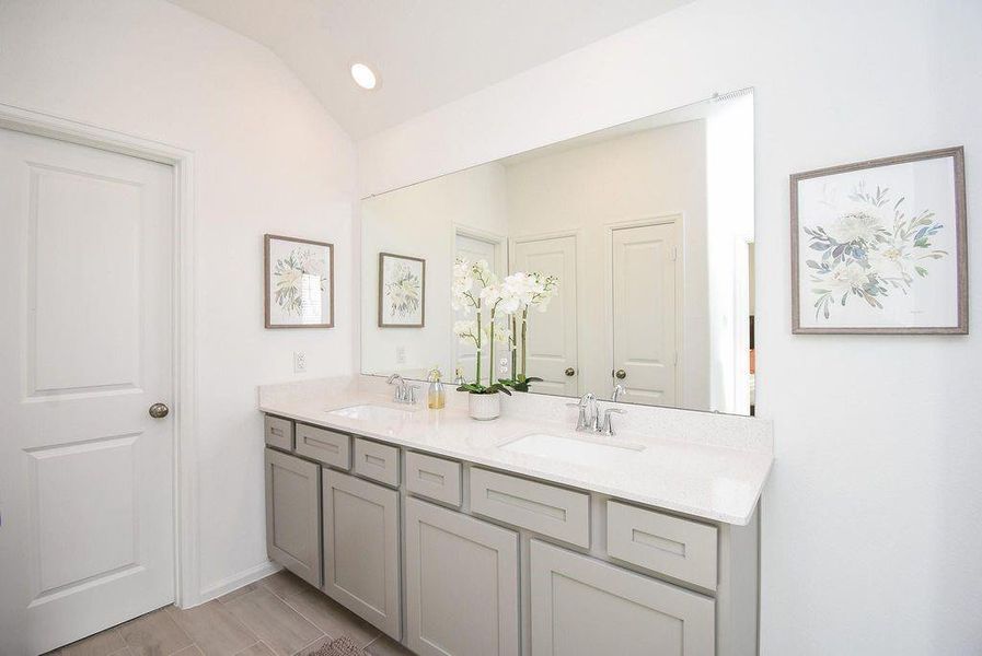 Pristine vanity area with abundant storage and soft tones for a calm morning routine.