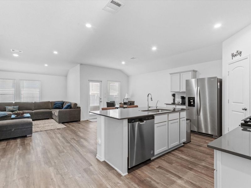 Open concept kitchen, living, and dining room with high ceilings