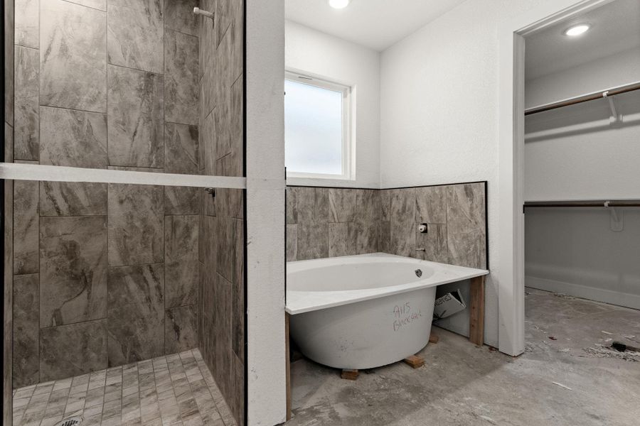 Bathroom with a spacious closet, a freestanding bath, and a shower stall Bathroom with a spacious closet, a freestanding bath, and a shower stall
