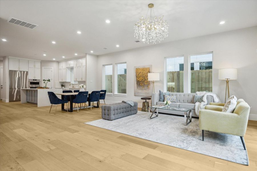 Living room - seamlessly flows to dining area and kitchen. Living room - seamlessly flows to dining area and kitchen.