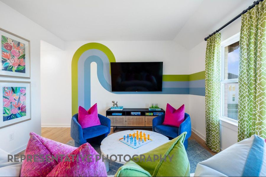 Living room featuring wood finished floors and vaulted ceiling Living room featuring wood finished floors and vaulted ceiling