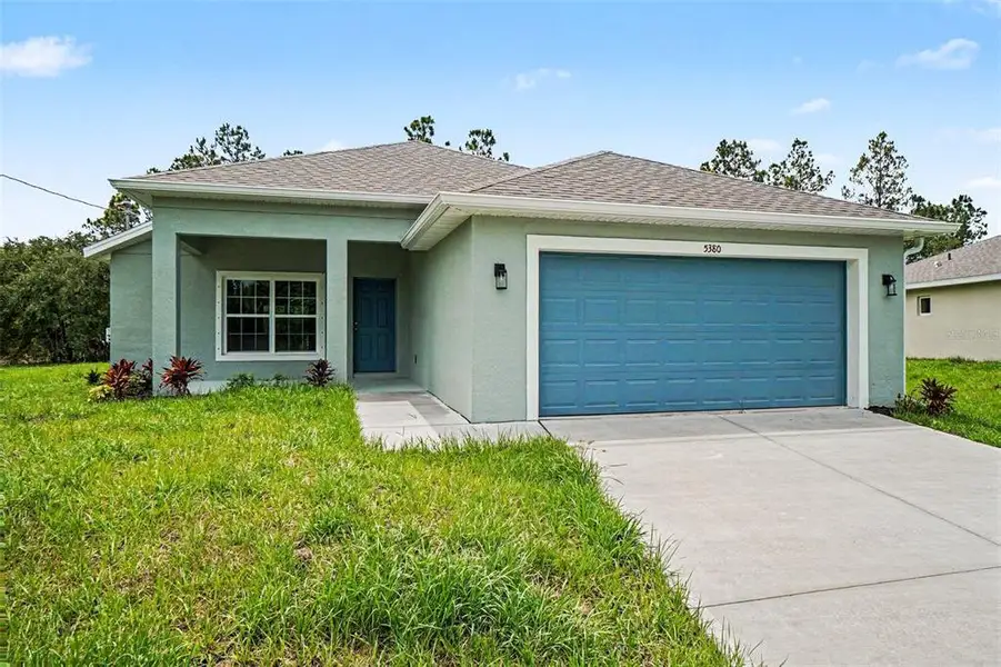 Front exterior of a new home in , North Port, FL, highlighting curb appeal (Image 2). Front exterior of a new home in , North Port, FL, highlighting curb appeal (Image 2).