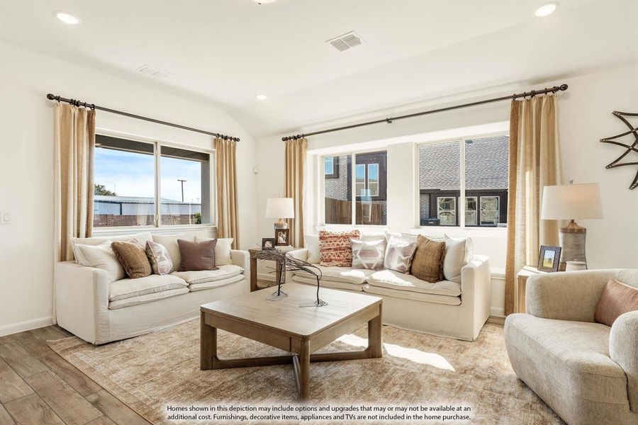 Living room with two white sofas, wood coffee table, area rug, and large windows with tan curtains