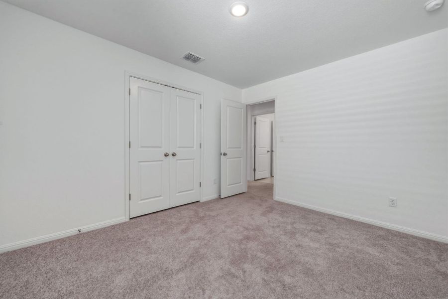 Unfurnished bedroom featuring carpet floors and a closet