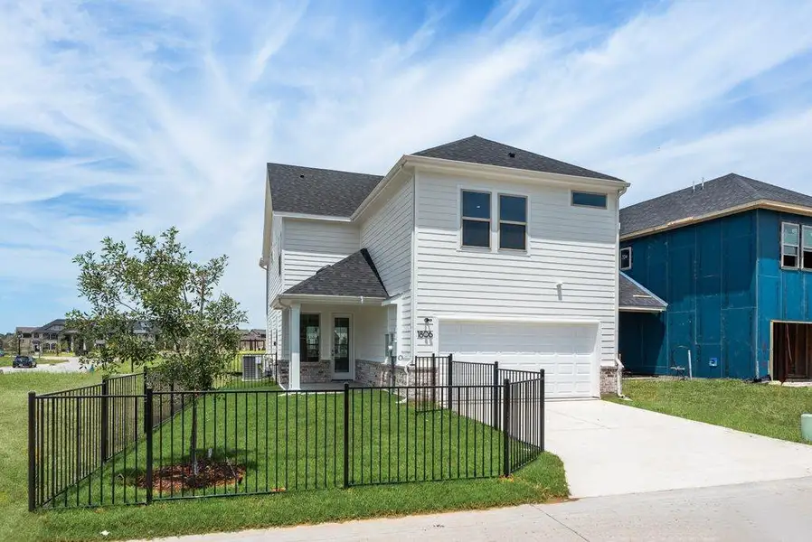 Front exterior of a new home in Bayside, Rowlett, TX, highlighting curb appeal (Image 24). Front exterior of a new home in Bayside, Rowlett, TX, highlighting curb appeal (Image 24).