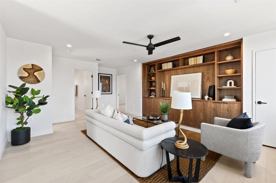 Upstairs media room with custom walnut built in cabinetry