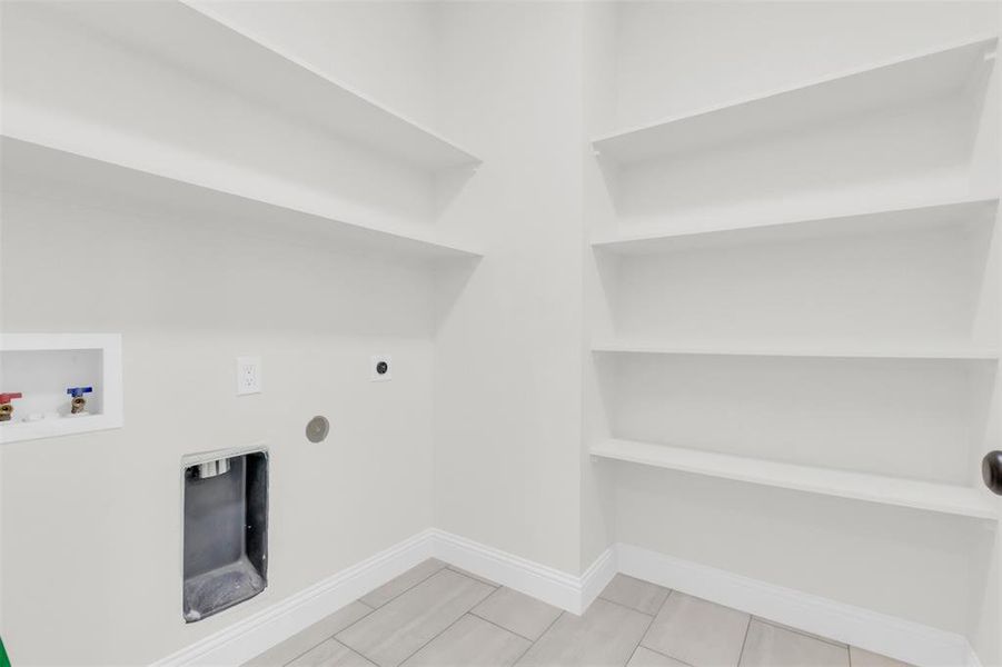 Laundry room with washer hookup, electric dryer hookup, and built in features