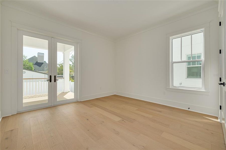 The downstairs guest room would be an excellent space for an office. The doors provide access to the outdoor living space.