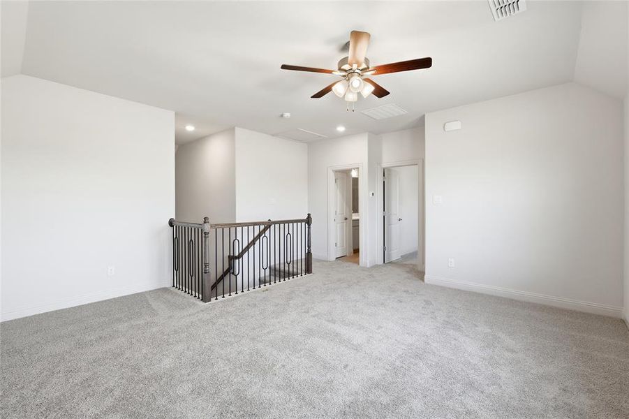 Unfurnished room featuring vaulted ceiling, light carpet, a ceiling fan, and recessed lighting Unfurnished room featuring vaulted ceiling, light carpet, a ceiling fan, and recessed lighting