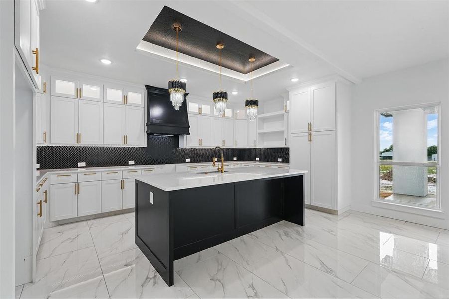 Kitchen with open shelves, a tray ceiling, backsplash, light countertops, and recessed lighting Kitchen with open shelves, a tray ceiling, backsplash, light countertops, and recessed lighting