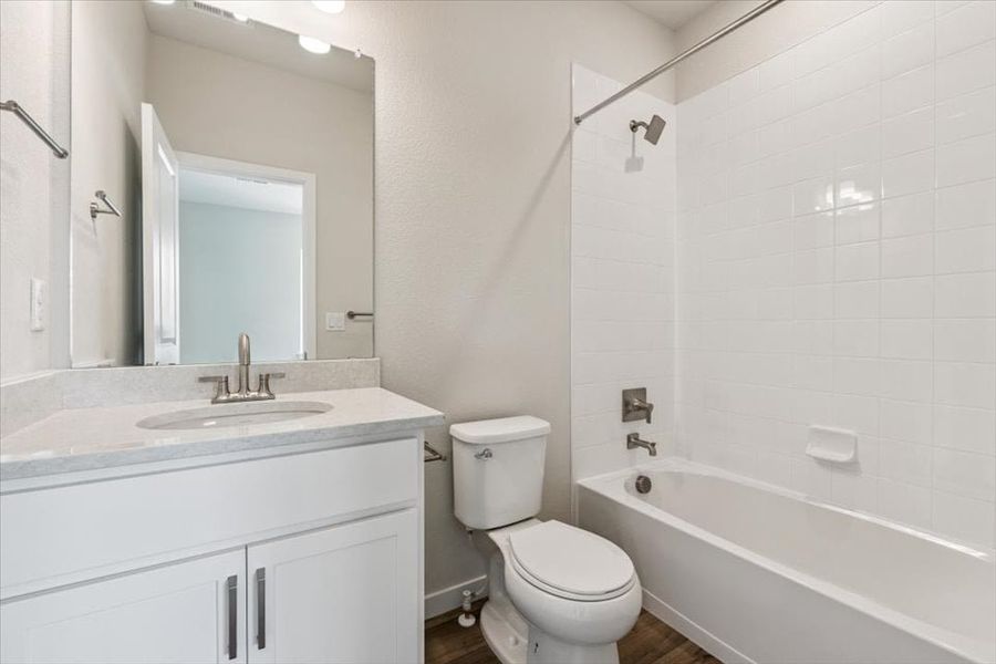 A bathroom with a toilet and sink.