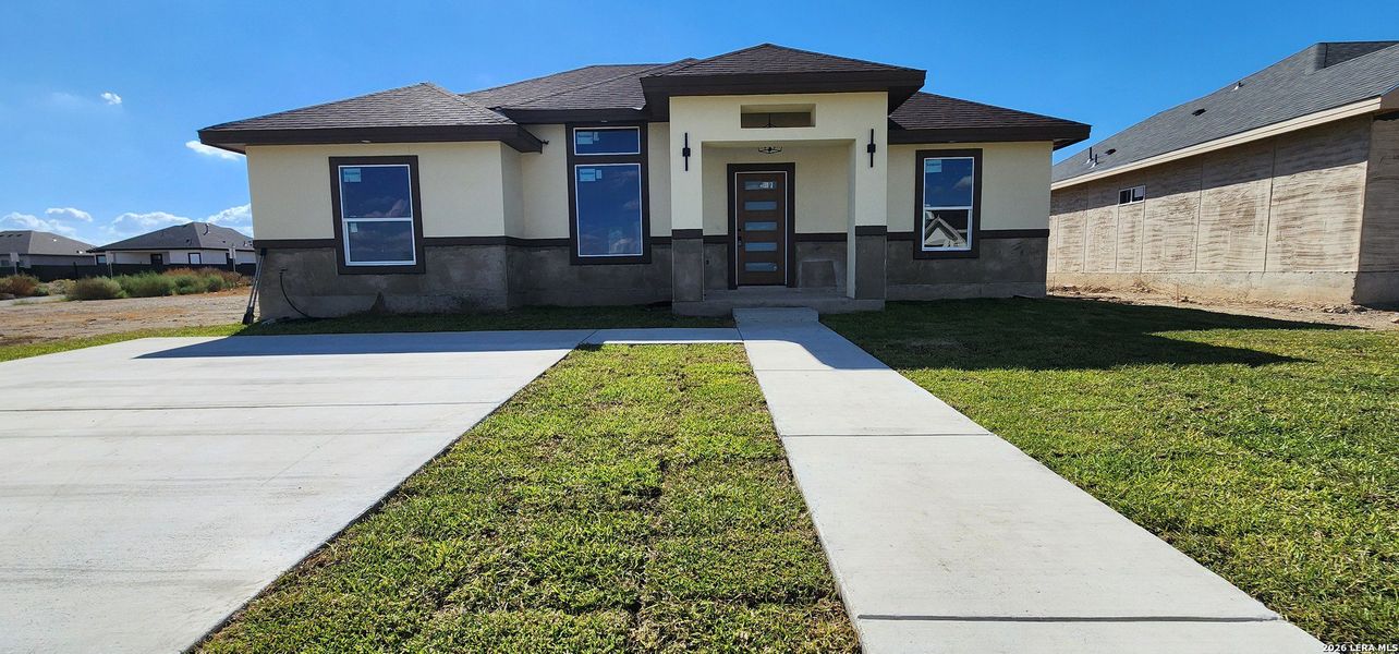 Front exterior of a new home in , Eagle Pass, TX, highlighting curb appeal (Image 10).
