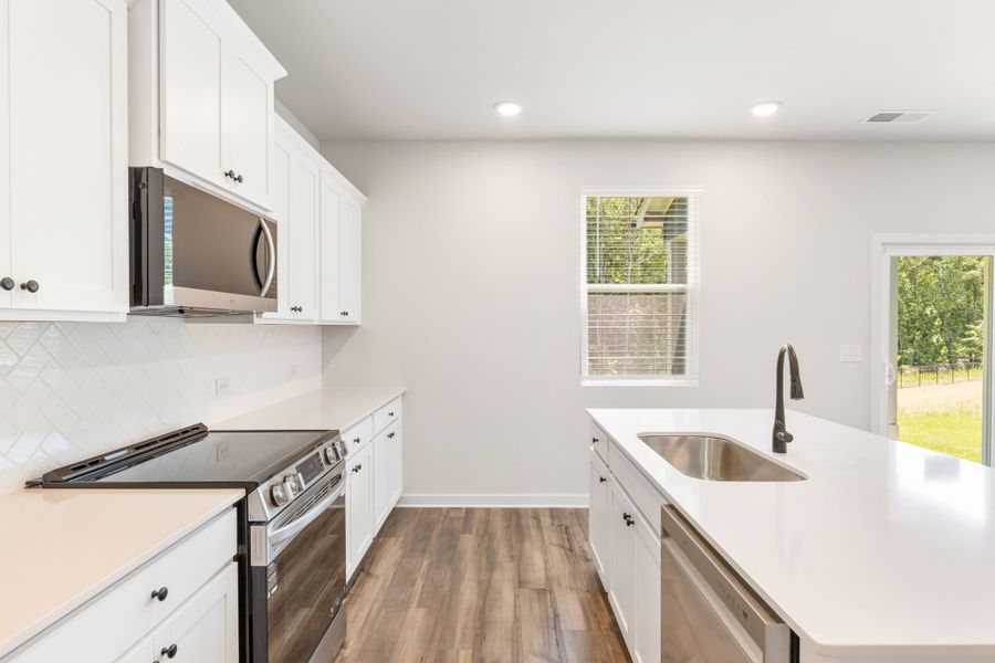 A kitchen with white cabinets. A kitchen with white cabinets.