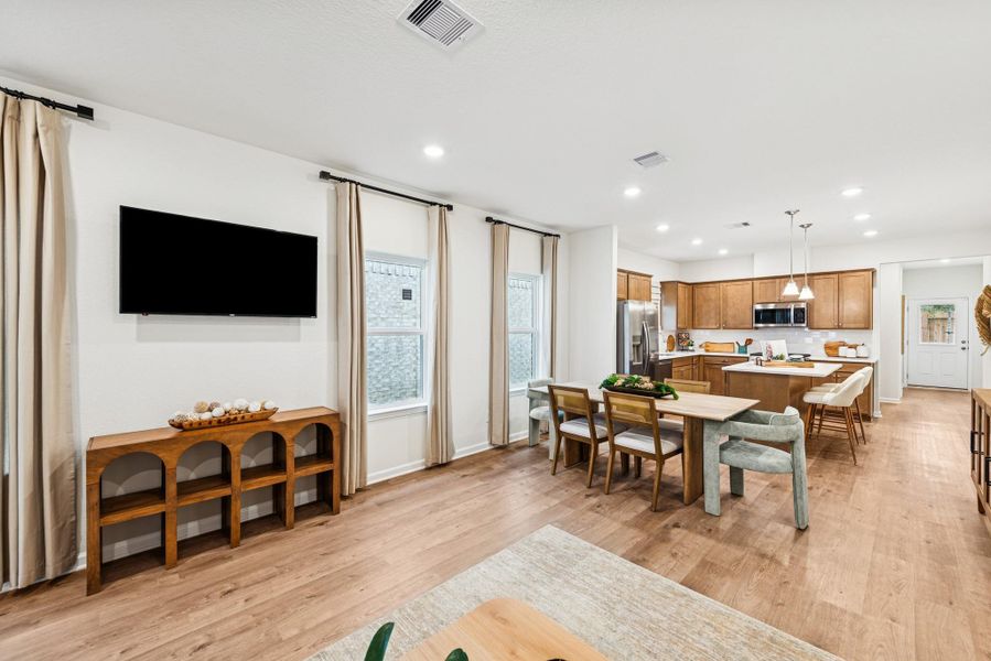 The Mockingbird II- Family Room into the Dining. Sample image for illustration; upgrades, options, and colors may vary.