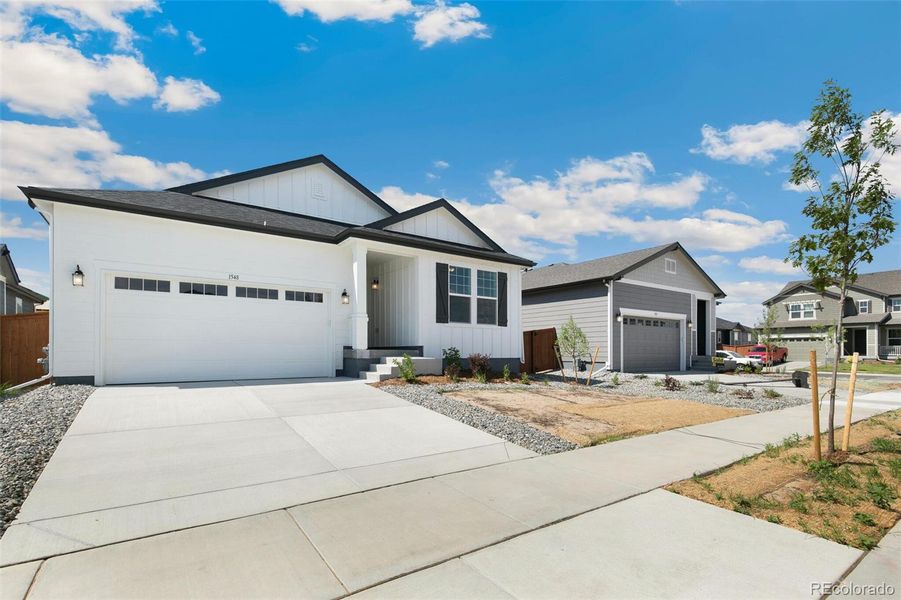 Front exterior of a new home in Farmlore, Brighton, CO, highlighting curb appeal (Image 20).